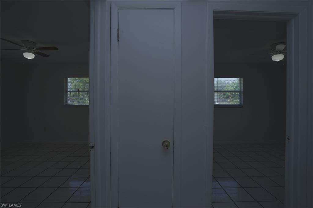 Each room features tiled flooring, a window with blinds, and a ceiling fan with an integrated light fixture