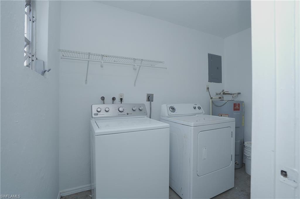 Dedicated laundry area featuring a washer, dryer, and an overhead wire shelf for storage