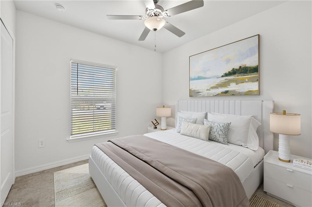 Bedroom with ceiling fan and light tile floors