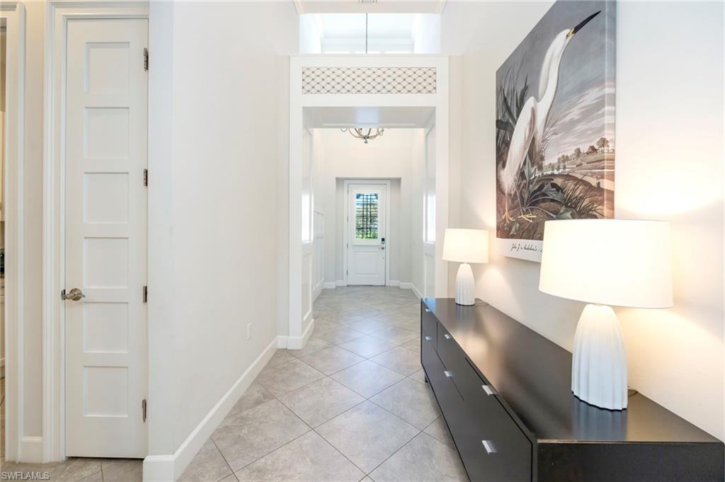 Elegant entry with volume ceilings, wainstcoting panels and elevated styling treatments