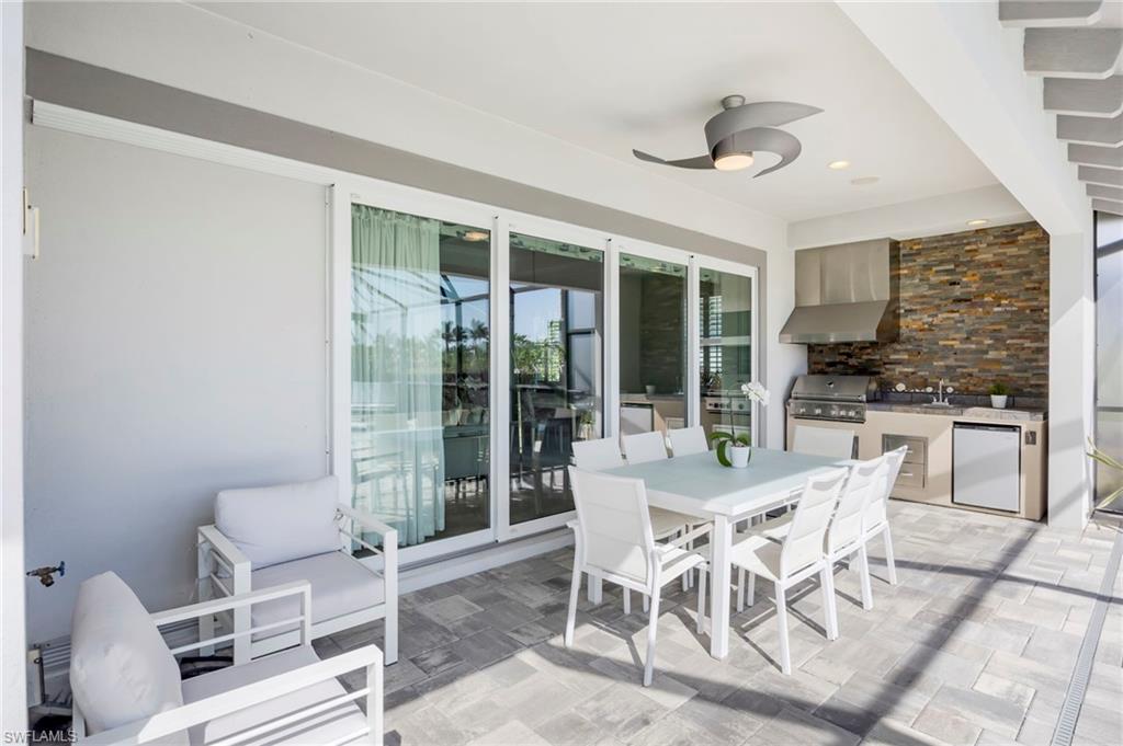 Large covered lanai has built-in speakers, outdoor kitchen with grill, hood, sink, beverage refrigerator