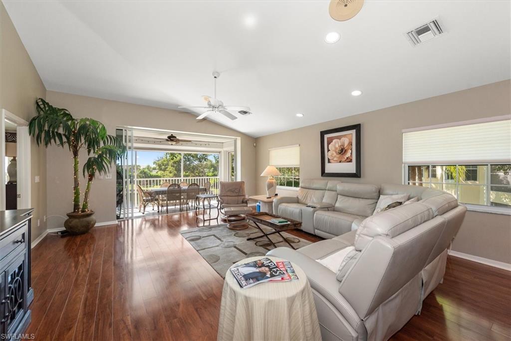 Spacious open Living Room with Hard wood floors facing lanai with comfortable leather recliners