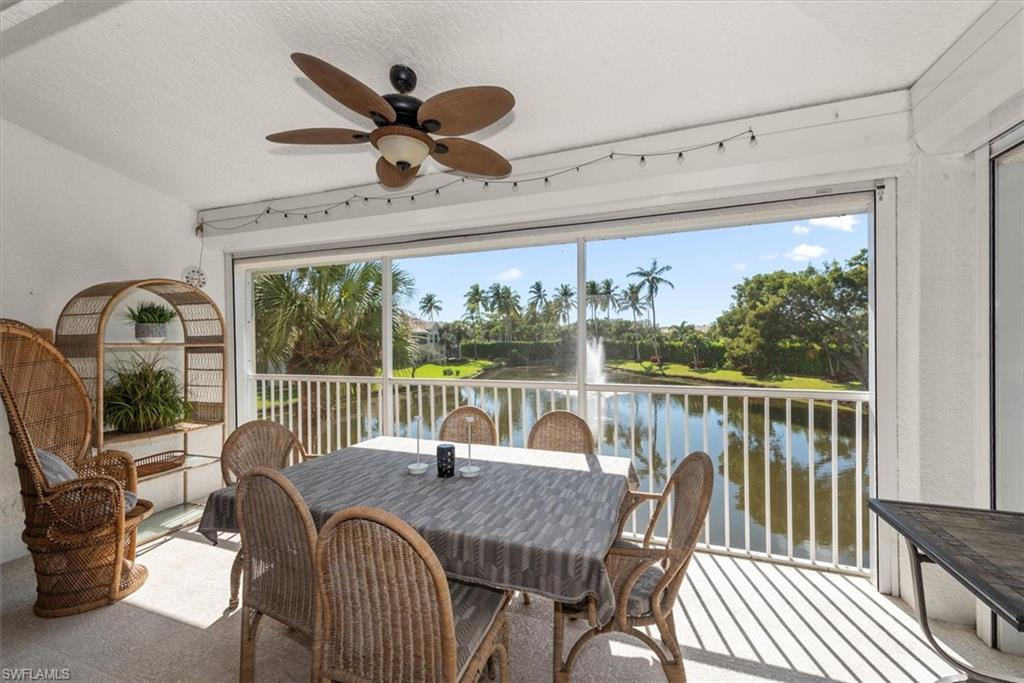 screened lanai with electric hurricane shutters overlooking lake and fountain