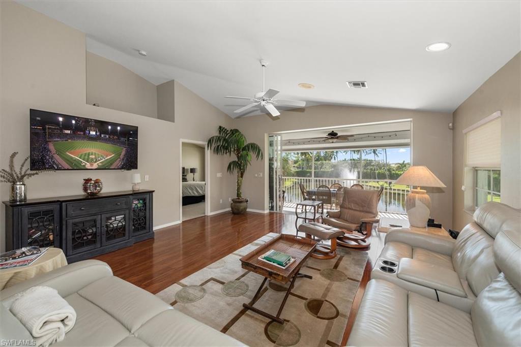 Tastefully decorated spacious Living room with large screen TV - lanai overlooks the lake
