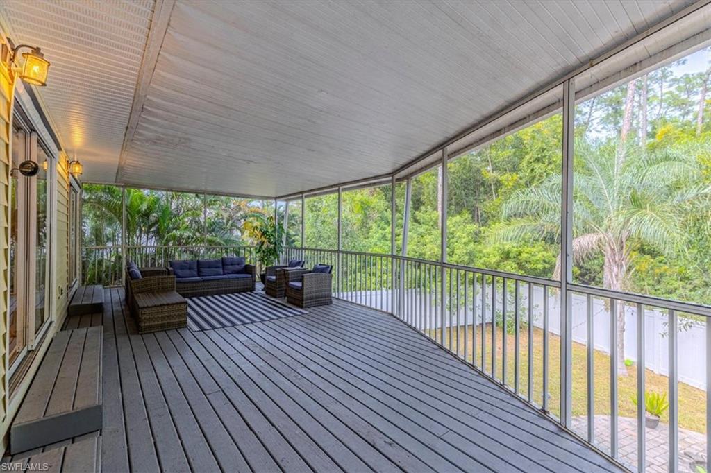 Deck featuring an outdoor hangout area and view of scattered trees