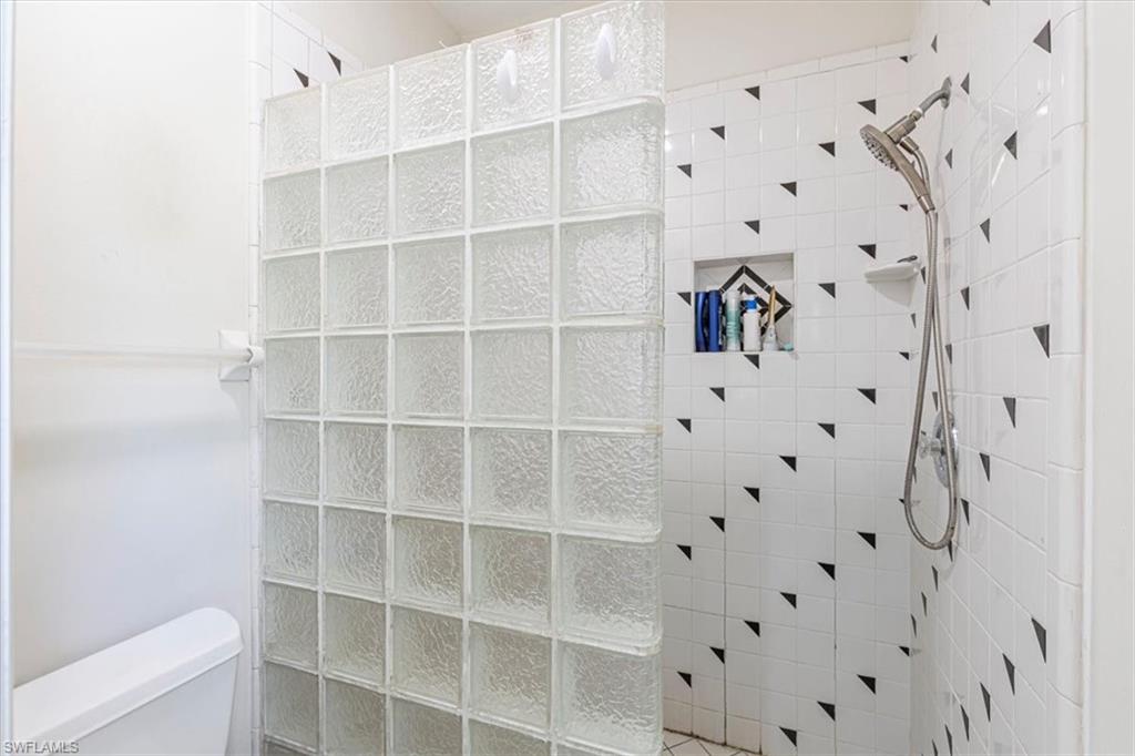 Full bathroom featuring a walk in shower and toilet