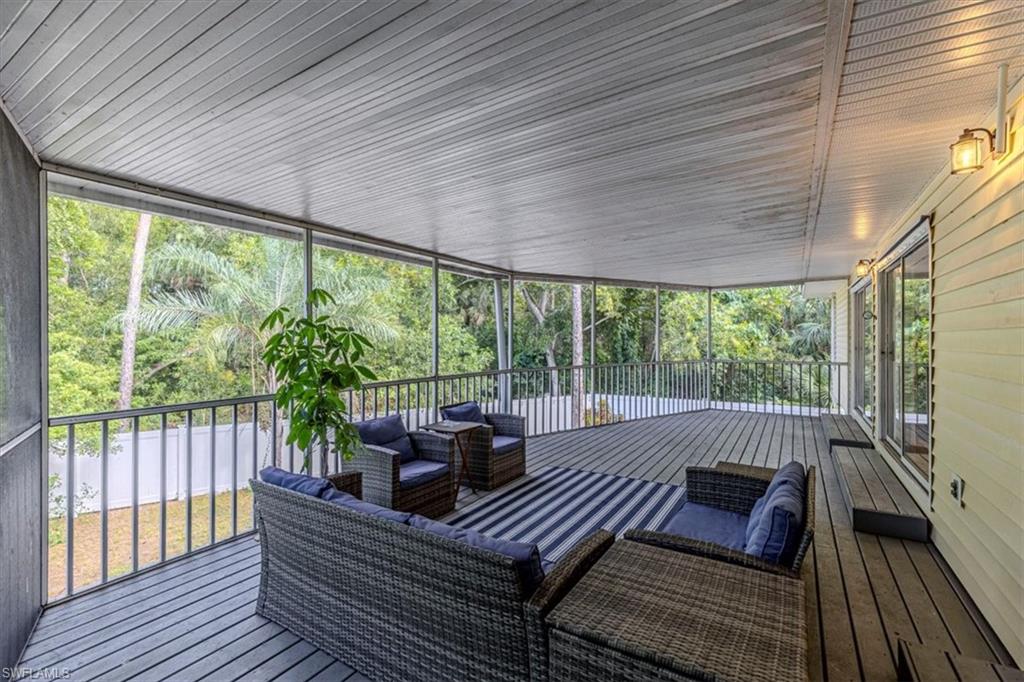 Deck with an outdoor living space and a sunroom