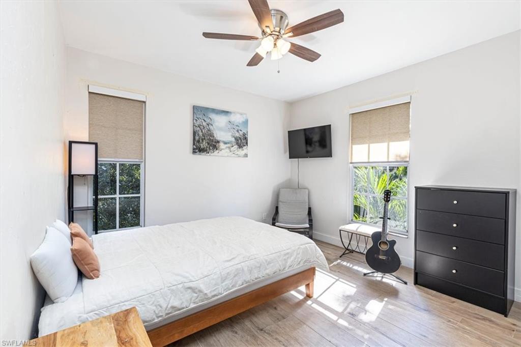 Bedroom with wood finished floors and ceiling fan