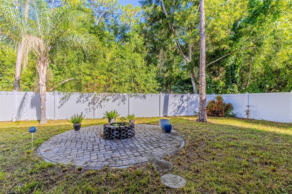 Fenced backyard featuring a patio