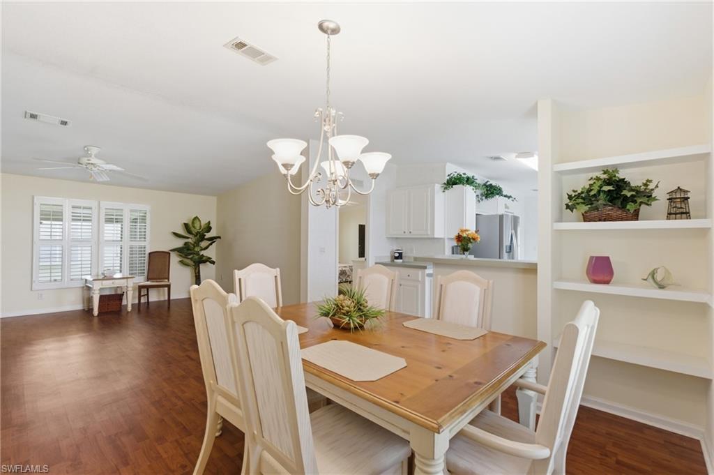 Dining area with Family room and Kitchen in background.