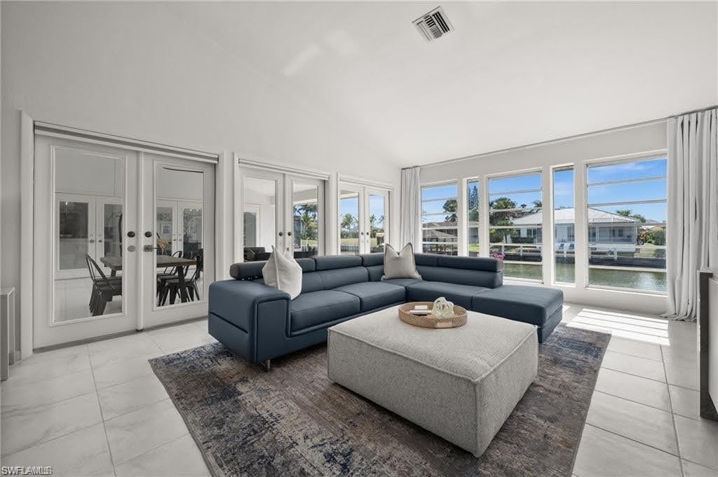 The primary bedroom sitting area overlooks the patio space and the canal