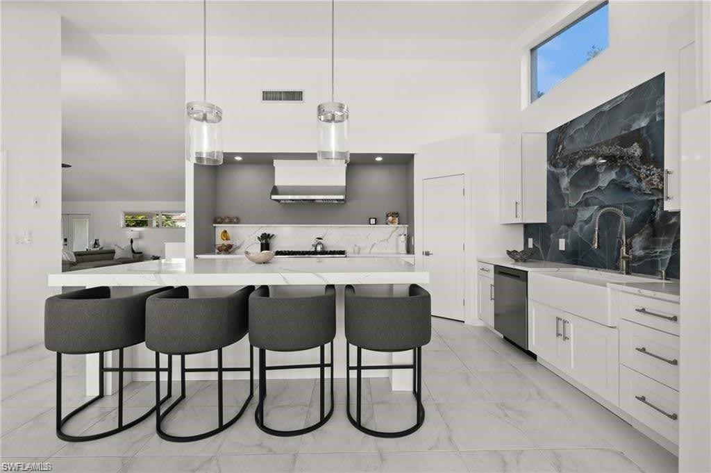 The remodeled kitchen features a large, spacious island