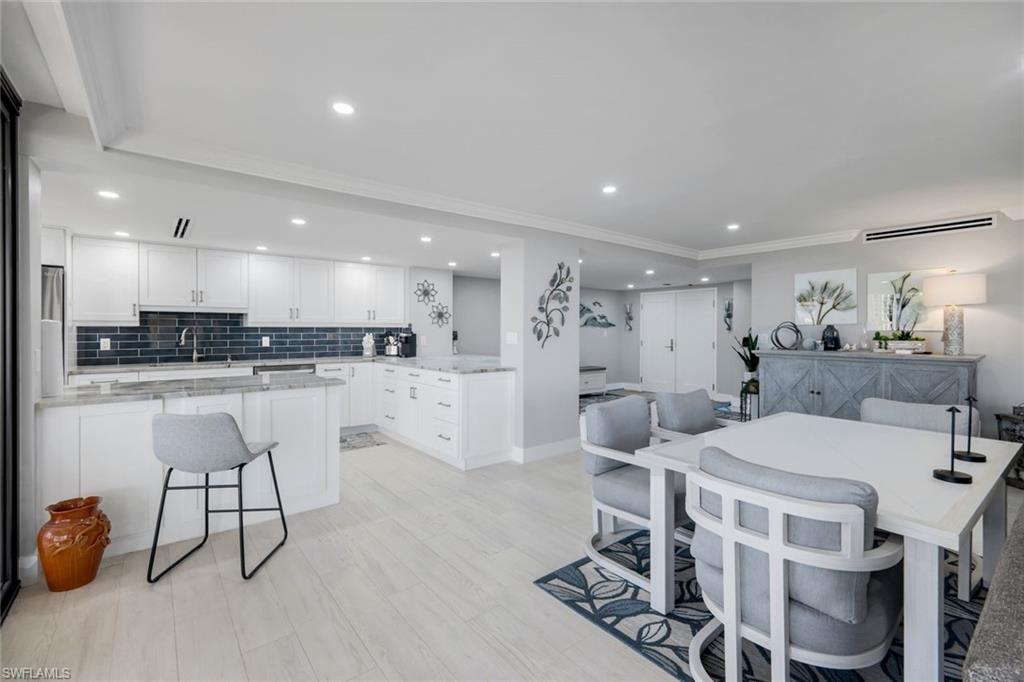 The property features an open-plan layout with light-colored flooring throughout