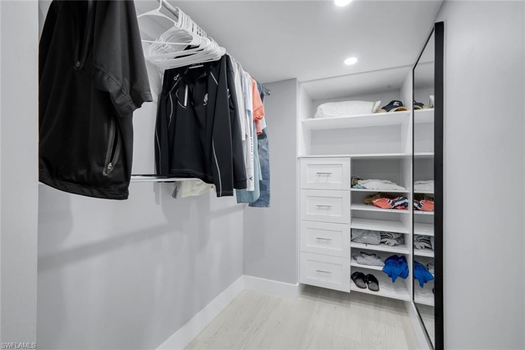 Custom closet with built-in shelving, drawers, and hanging rods