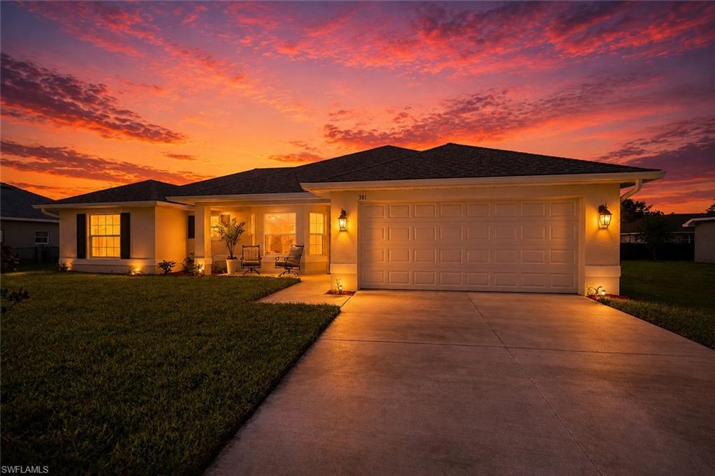 Contemporary single-story residence featuring a two-car garage, concrete driveway, and covered entry