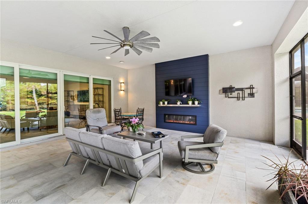 exterior patio features beautiful fireplace accent wall and 12 blade fan for maximum air movement