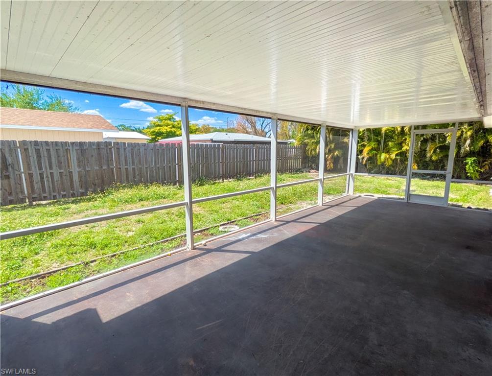 The property features a screened-in patio with a concrete floor and a white paneled ceiling