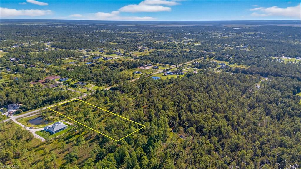 Aerial overview of property's location with property boundaries highlighted and a forest