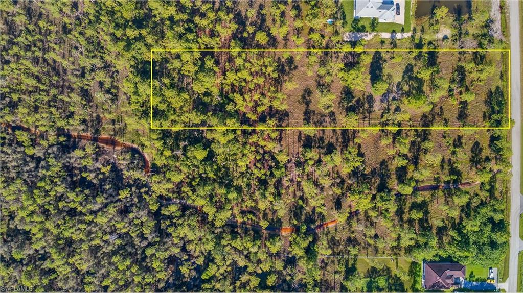 Aerial view of property's location featuring property parcel outlined