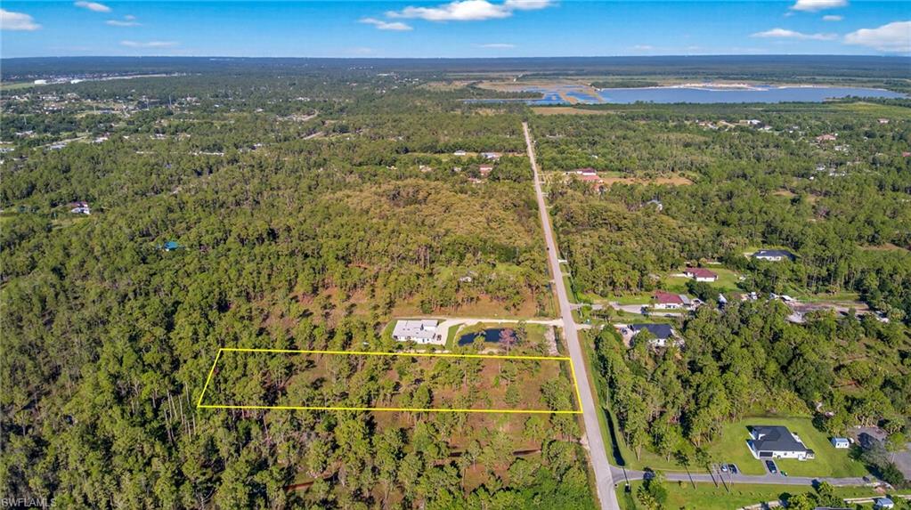 View of property location with a nearby body of water and property parcel outlined