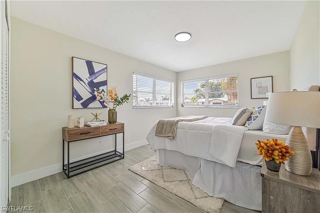 The room features light-colored walls and large windows with horizontal blinds, allowing for natural light