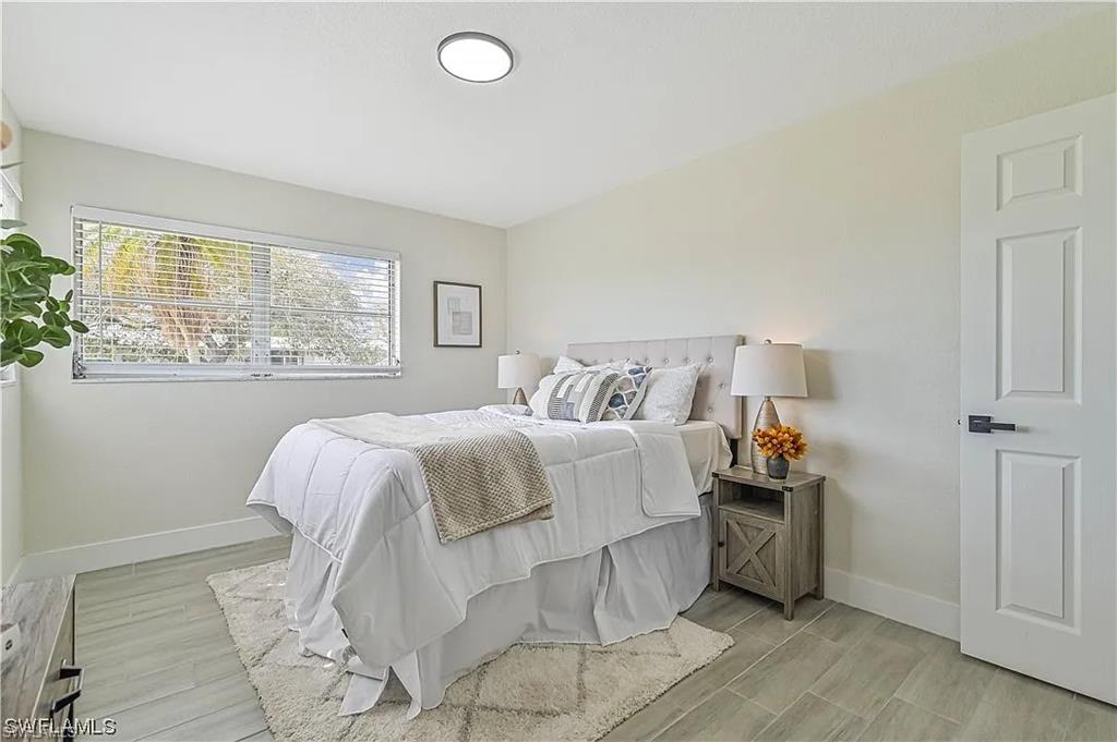 This room features light-colored walls and a window with blinds, allowing for natural light