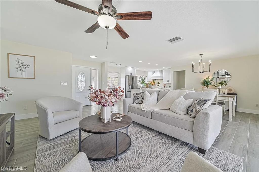 Open concept living space featuring a ceiling fan, tiled floors, and recessed lighting