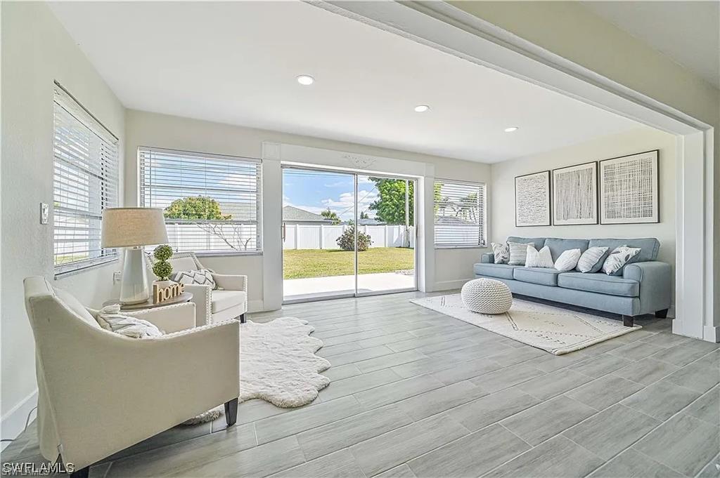 The interior features light-colored walls and large windows, providing ample natural light