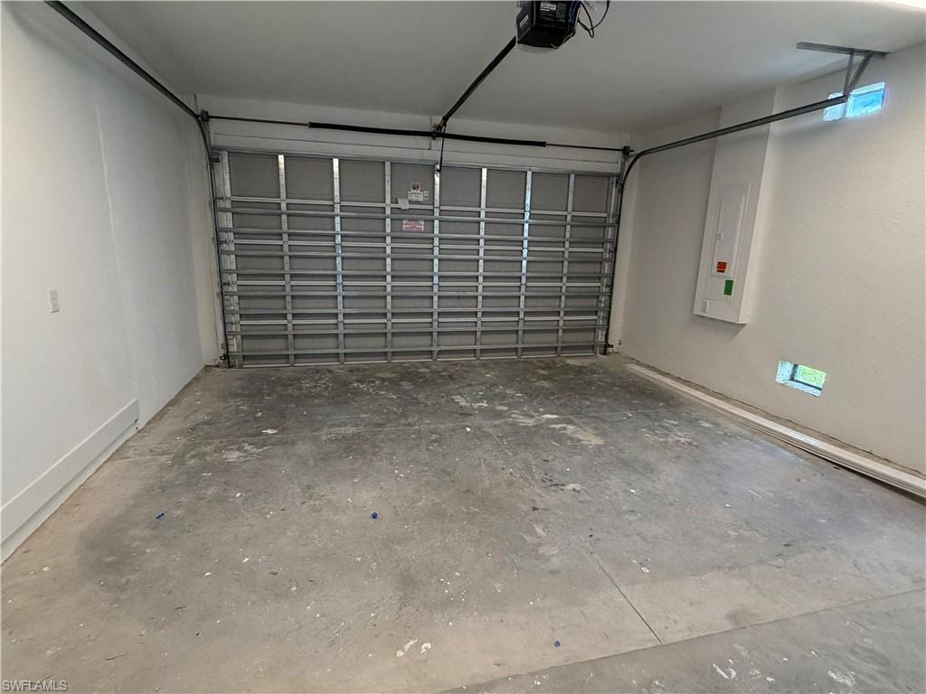 The property features a garage with a roll-up door and a concrete floor