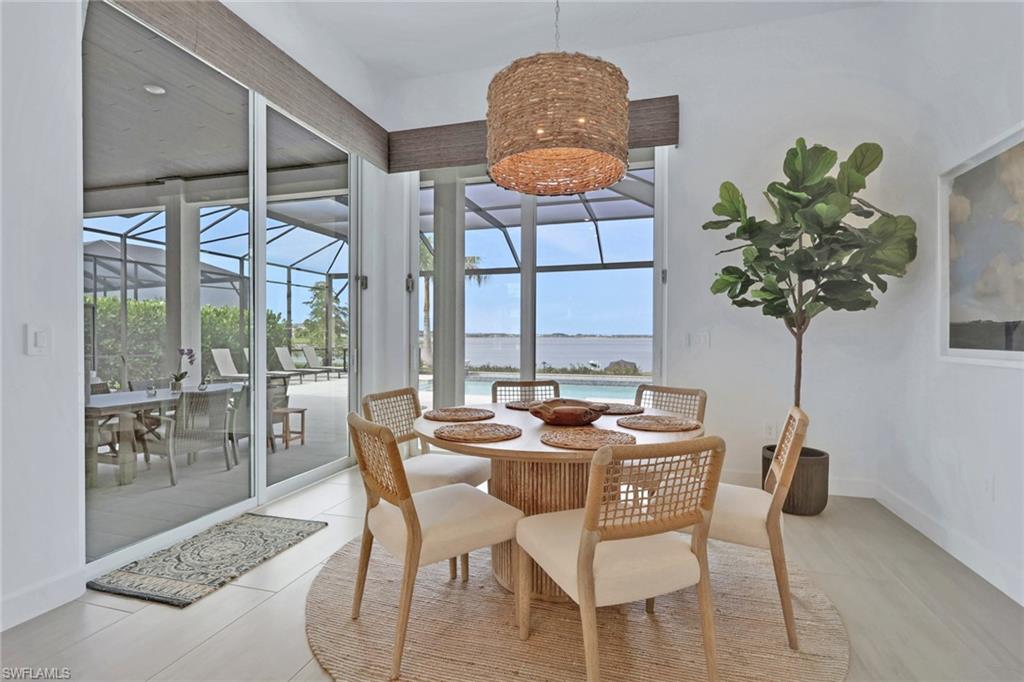 Dining area featuring a woven pendant light fixture and white walls
