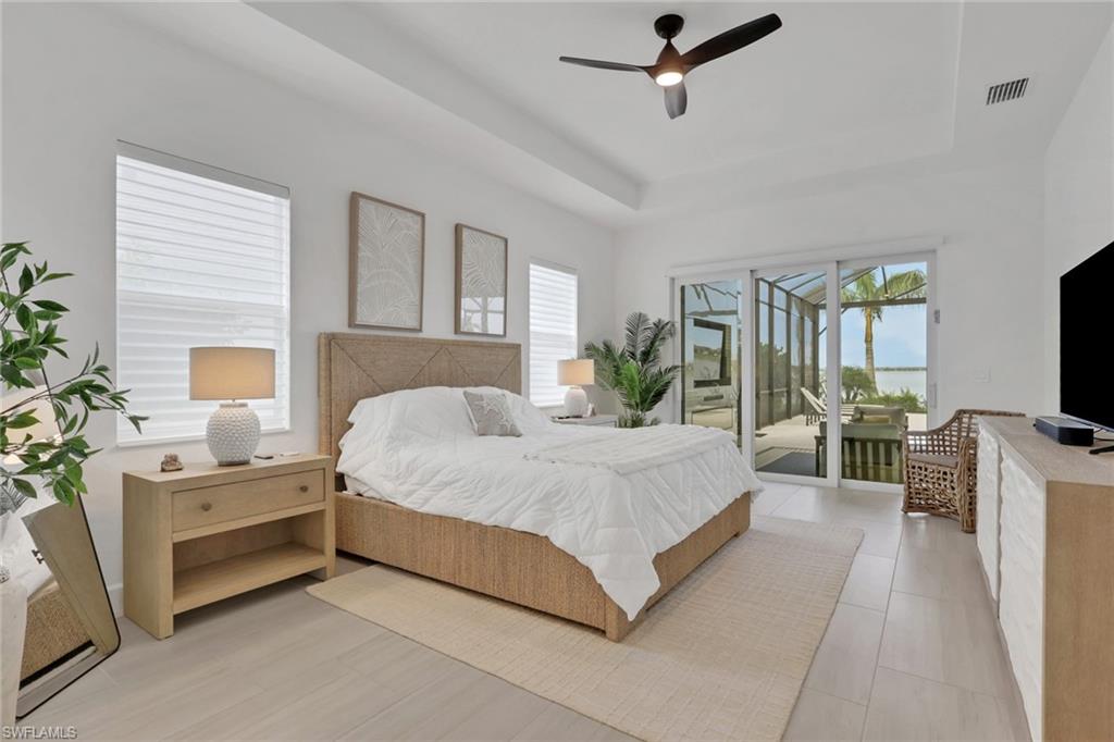 Spacious room with tray ceiling and recessed lighting
