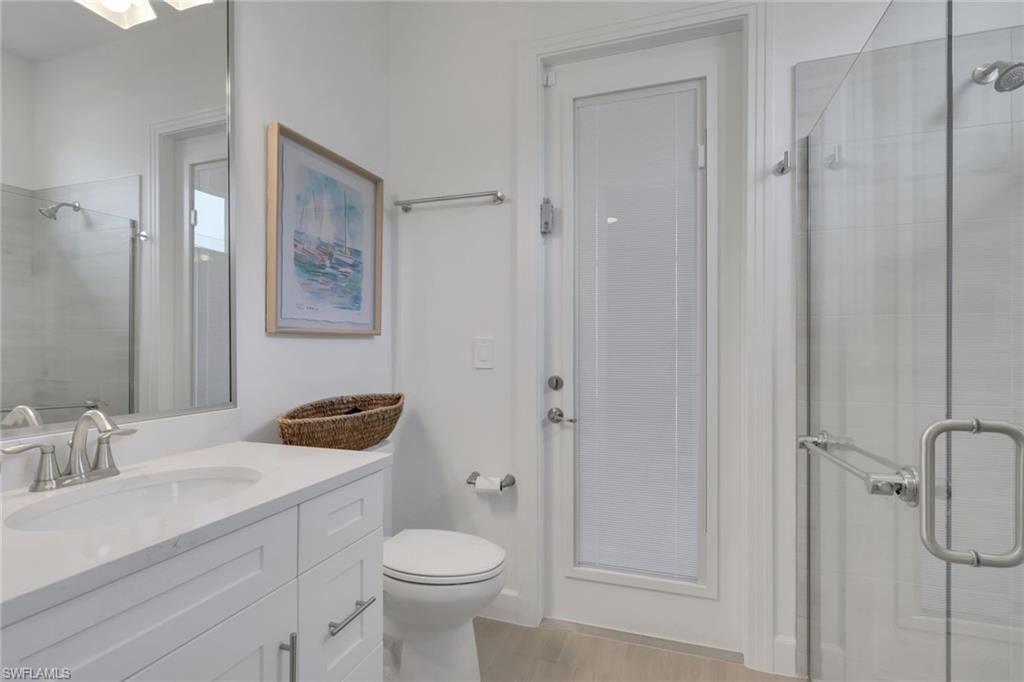 Modern bathroom with a white vanity featuring a rectangular sink, brushed nickel faucet, and white countertop