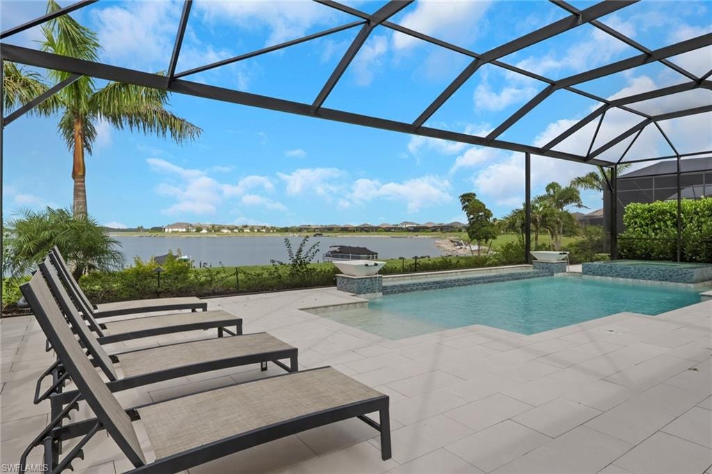 Screened outdoor patio featuring a swimming pool, integrated spa, and expansive lake scenery