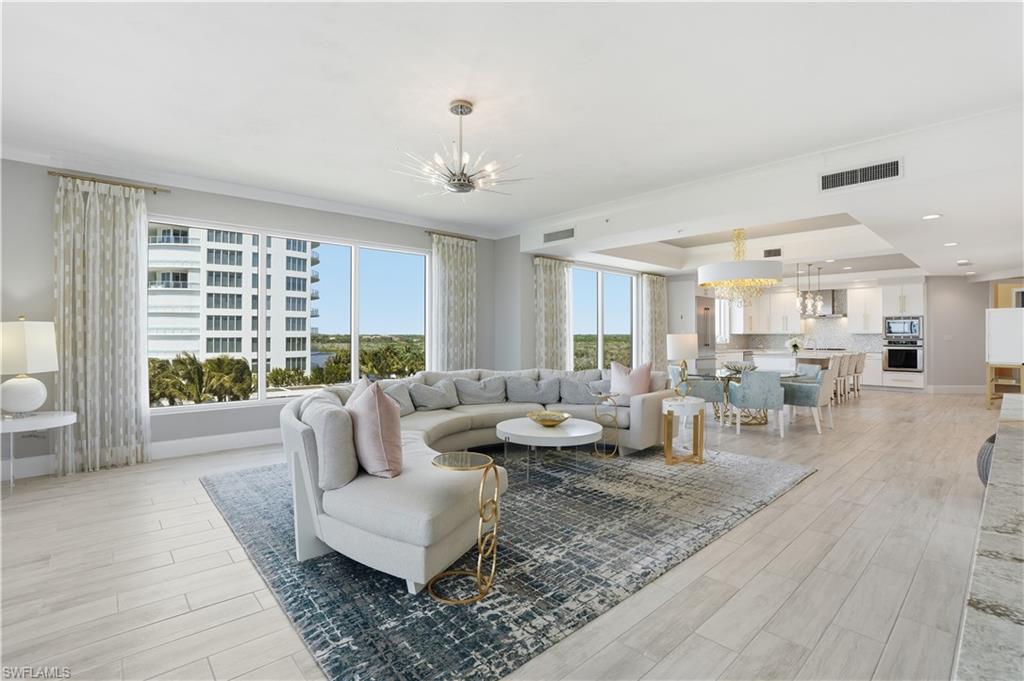 The large great room offers floor to ceiling windows with ample gathering space for friends and family.