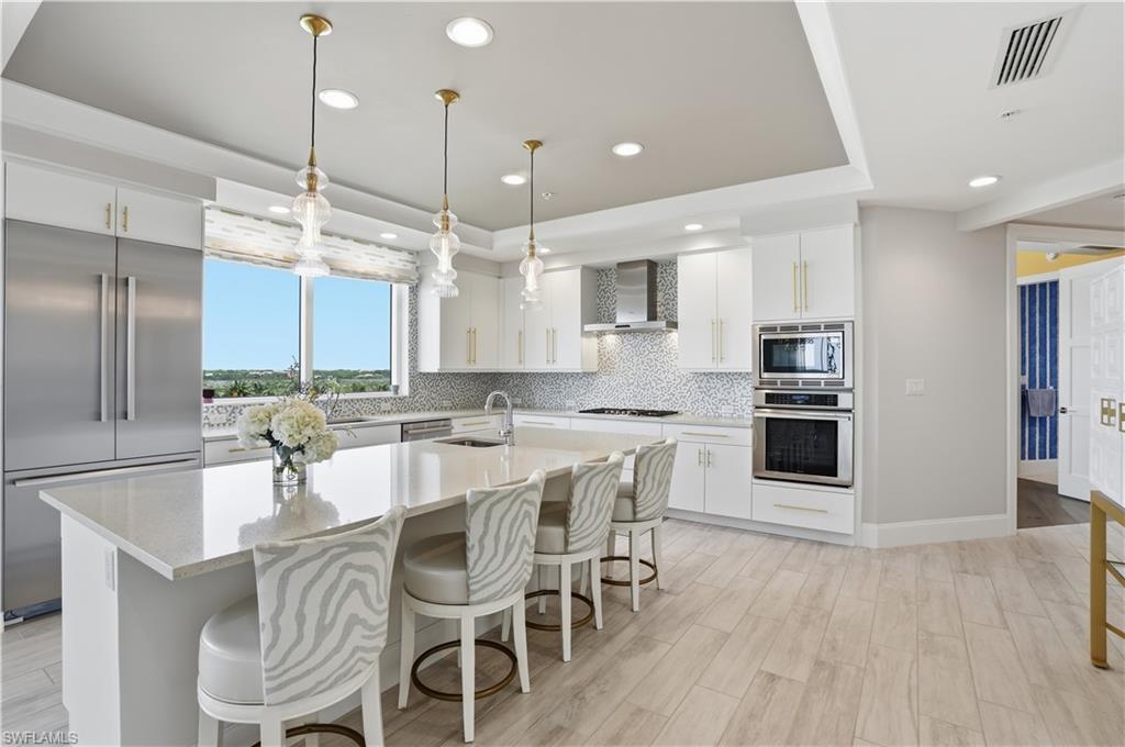 Gas stovetop, a huge island, pendant lighting, TWO sinks and so much more!