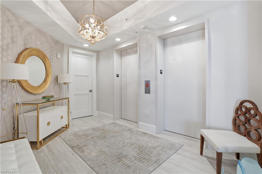 A stately entryway. Through the side door is the trash chute and stairway.