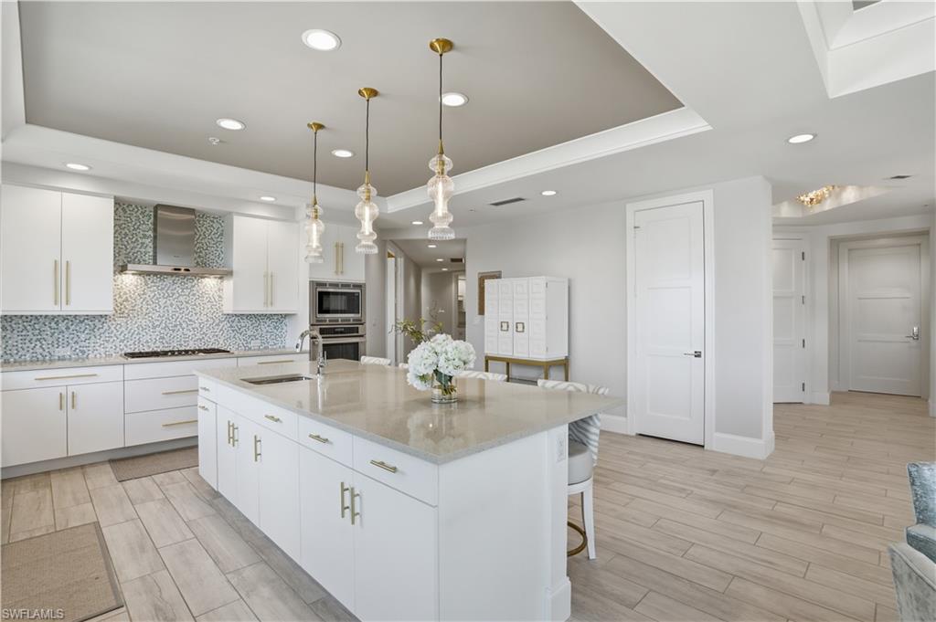 Notice the hallway from the kitchen leading to the den and guest suites. This home allows so much privacy for owners and their guests!