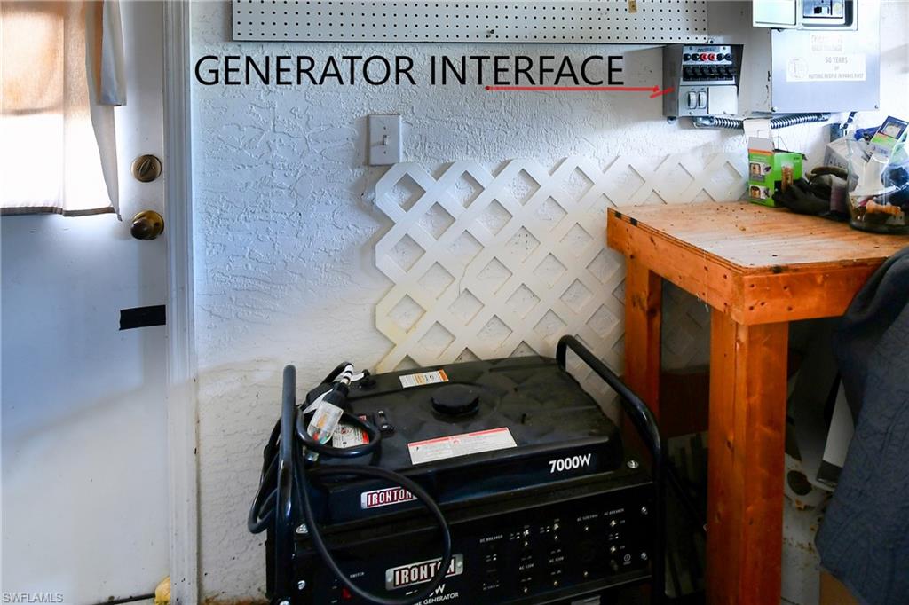 Utility area featuring a generator interface, a generator, and a wooden workbench