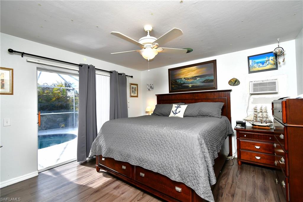 The room features durable wood-look flooring and a ceiling fan for comfort