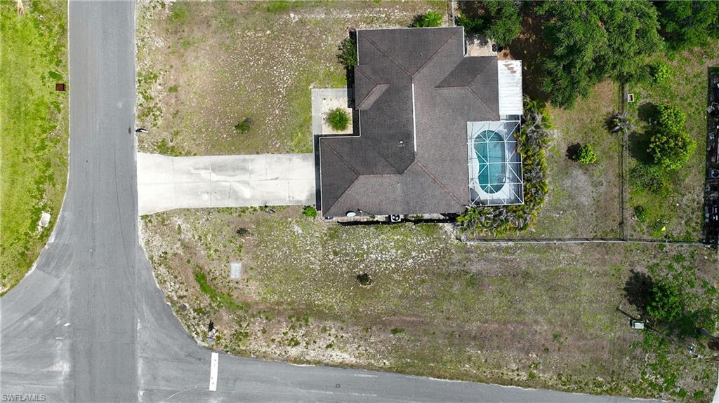 The property features a private swimming pool with a screened enclosure