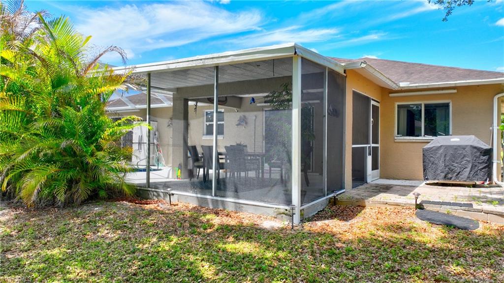 The property features a screened-in patio area with ample space for outdoor dining