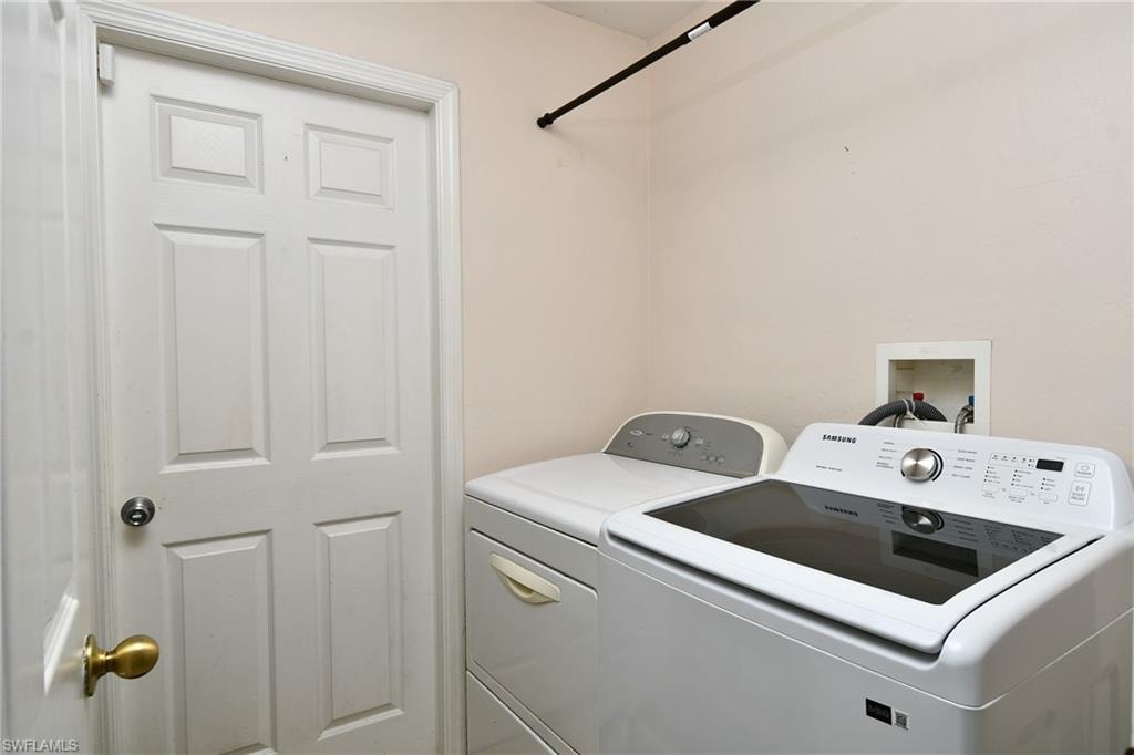 Dedicated laundry area featuring a white paneled door and light-colored walls
