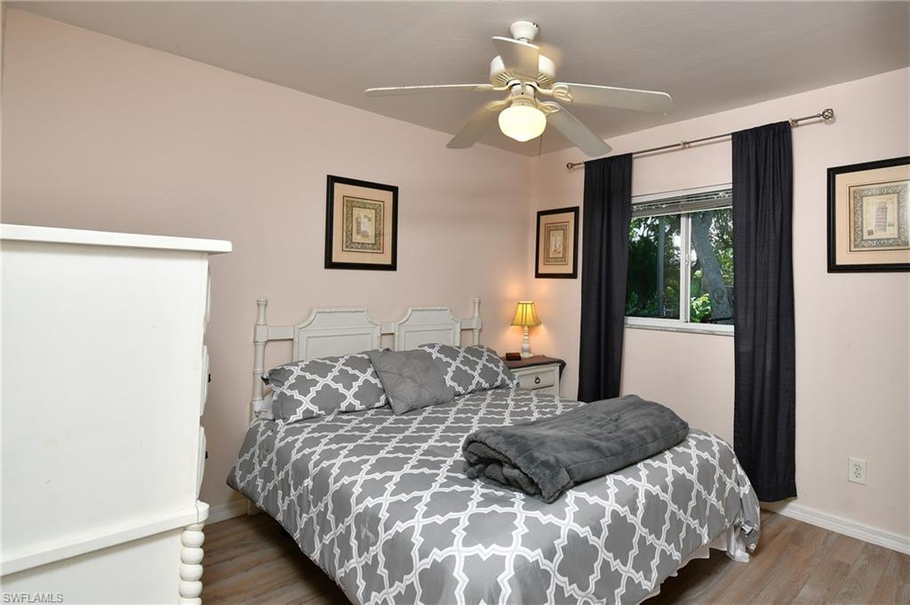 A comfortable room featuring a ceiling fan, a window, and light-toned flooring
