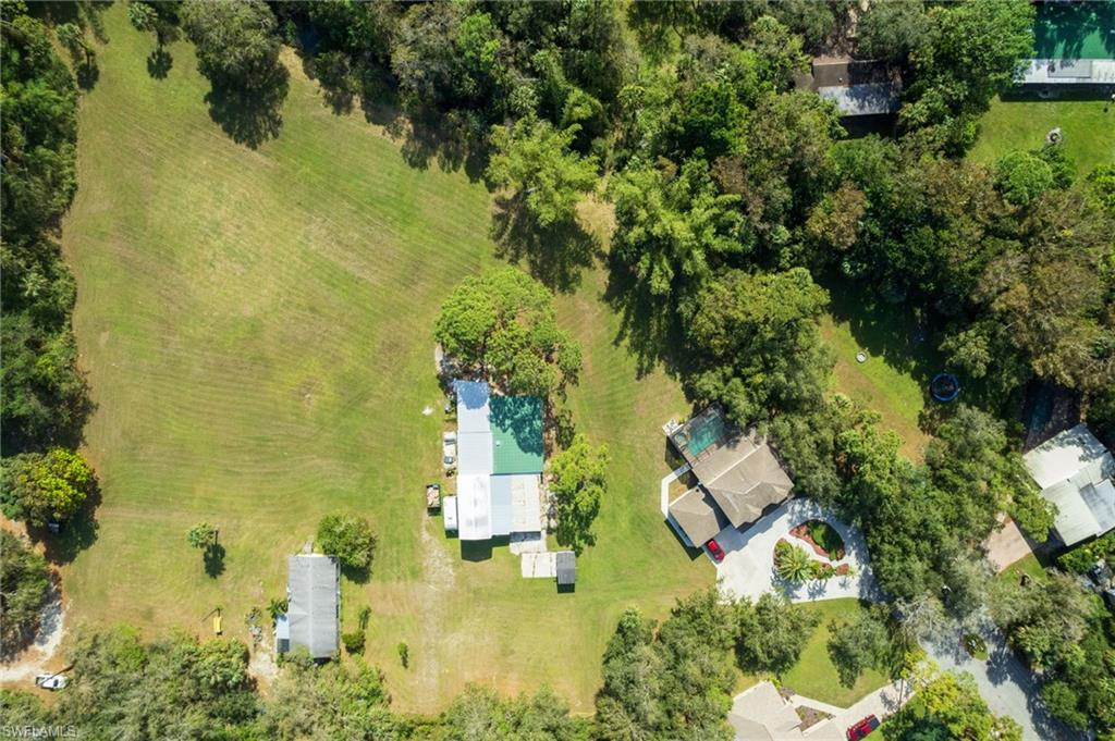 Expansive cleared land parcel offering substantial open space bordered by mature trees