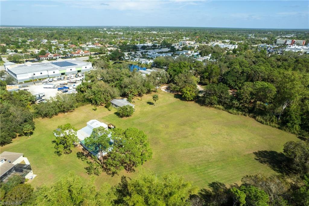 Expansive green space featuring scattered mature trees and foliage