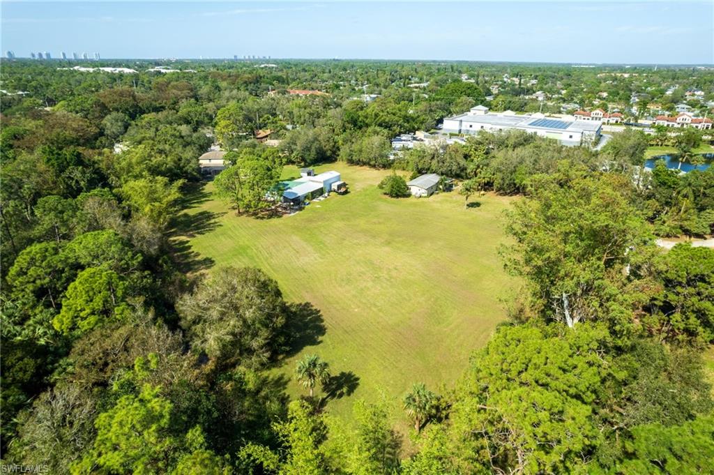 Expansive green lot with established perimeter trees, offering a private setting