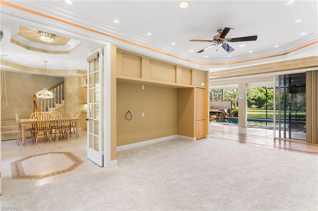 Carpeted interior space featuring a built-in media niche, ceiling fan, and recessed lighting