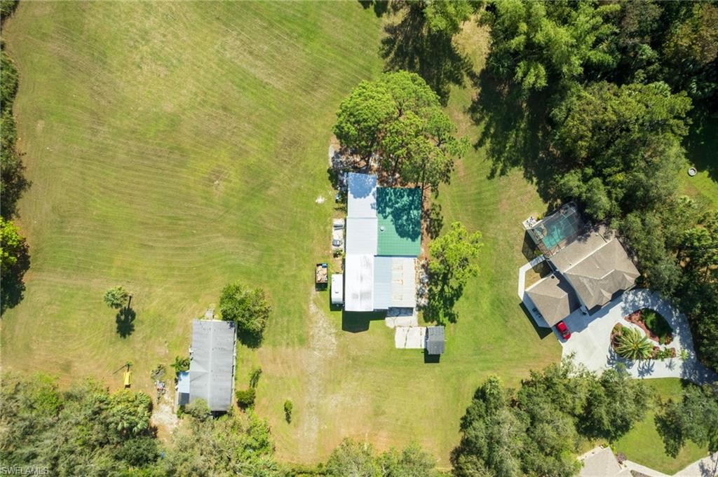 Expansive grounds featuring multiple structures and ample green space