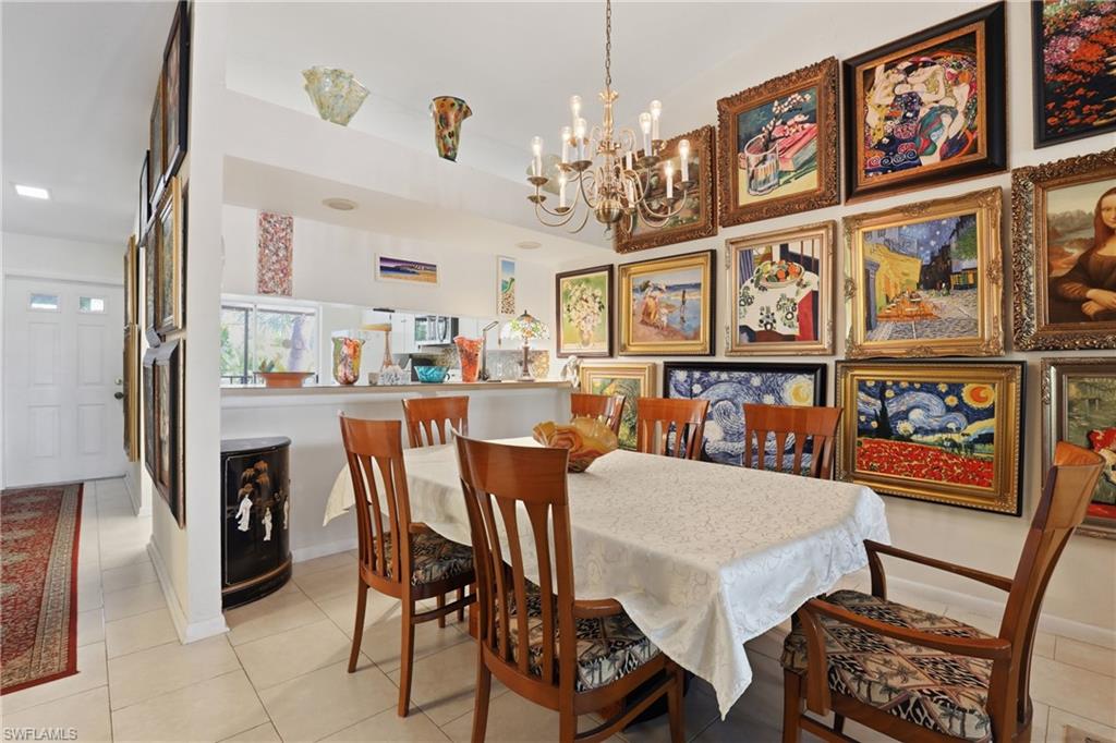Dining area featuring a classic chandelier and tile flooring
