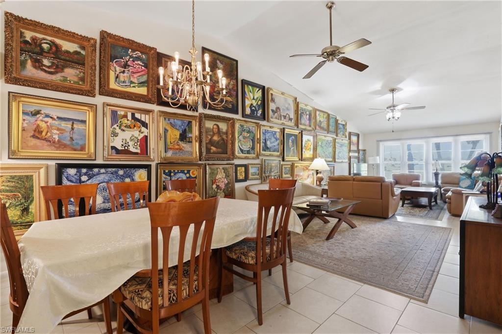 Spacious open-concept living area featuring high ceilings, recessed lighting, and multiple ceiling fans
